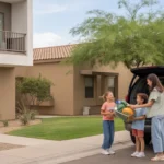Neighbors wave to each other from condo balcony and house driveway in sunny Goodyear, Arizona suburb
