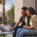 A couple video chats with family from the patio of their new Phoenix townhome at sunset.