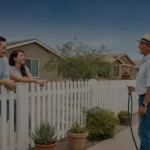 Couple chats with neighbor over fence in front of home in Surprise, AZ