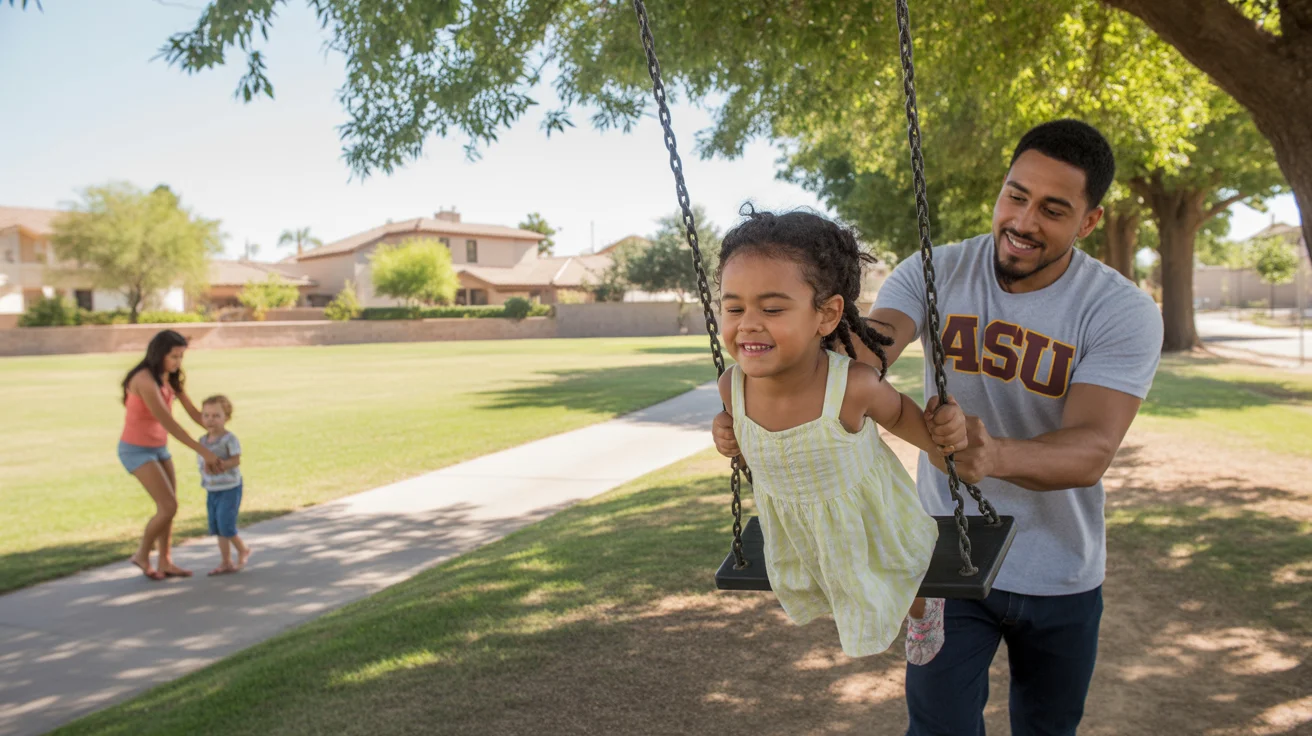 Father pushing his young daughter on a tree swing in a park in Glendale, Arizona