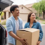 Couple unloading moving boxes in front of their new suburban home in Mesa, AZ