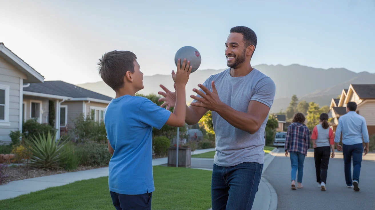 Father and son playing catch in front yard of Ontario home at sunset