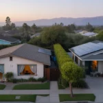 Aerial view of two homes in Anaheim, CA at sunrise, with open windows and solar panels