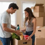 Couple unpacking groceries in new San Marcos apartment kitchen