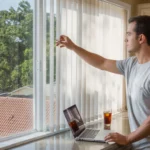 Man adjusting blinds in sunny apartment in Brandon, FL