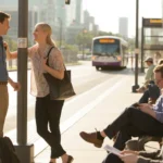 Two coworkers chatting at the Lakeland Bus Terminal while waiting for their evening commute.