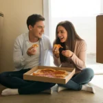 A couple eats pizza on the floor of their new, unfurnished apartment in Paradise, NV