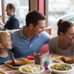 A young family enjoys dinner together at a cozy diner booth in Marietta, Georgia