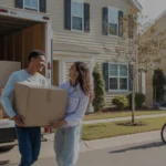Couple unloading moving boxes from truck in front of their new condo in Douglasville, Georgia
