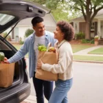 Couple unloading groceries from car trunk outside their home in Douglasville, Georgia